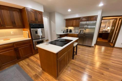 a large kitchen with wooden cabinets and a counter top at Turret House at Birchwood in Harbor Springs
