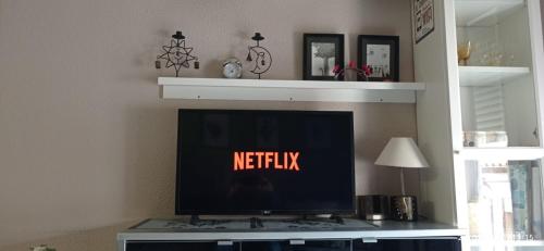 a flat screen tv sitting on top of a table at Apartamento Oliver in Calella