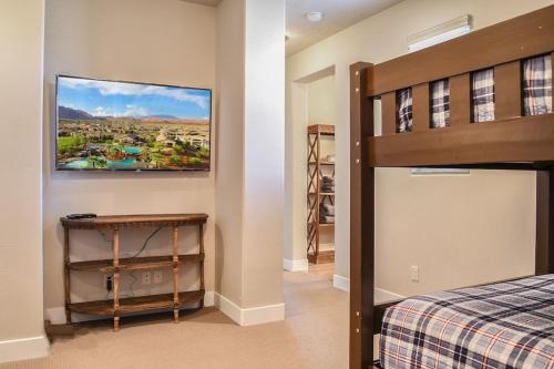 a bedroom with a bed and a painting on the wall at Paradise Village 32 BBQ Grill, Foosball, Pink Pong, Nintendo Switch and a Resort Style Pool and Water Park in Santa Clara