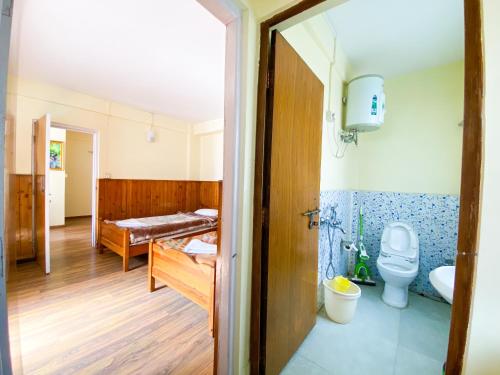 a room with a bathroom with a toilet and a sink at Augusta Villa in Darjeeling