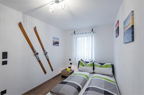 a bedroom with a bed with green and white pillows at Seelodge in Bad Bayersoien