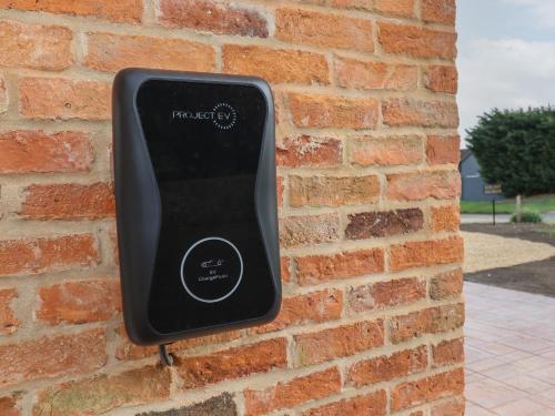 a thermostat on a brick wall at The Old Stables in Oasby