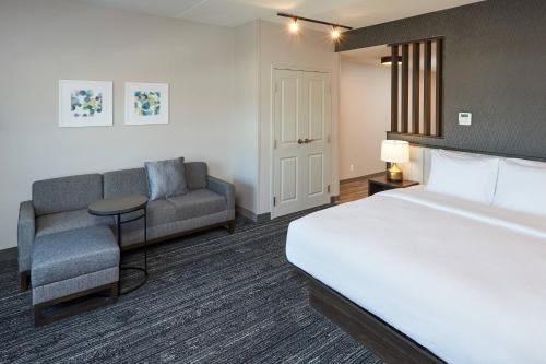 pokój hotelowy z łóżkiem i kanapą w obiekcie TownePlace Suites by Marriott Hamilton w mieście Hamilton