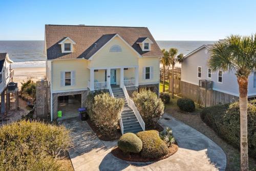 an aerial view of a house with the ocean at 1015 E Arctic Ave Dolphins Folly Oceanfront Home in Folly Beach
