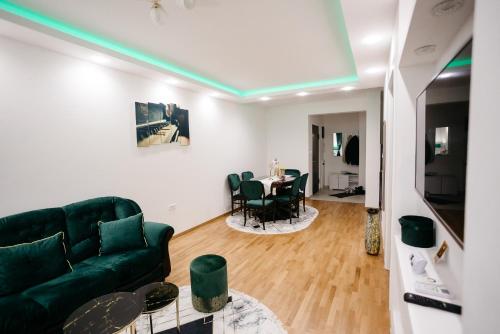 a living room with a green couch and a table at Apartman Dalija in Valjevo