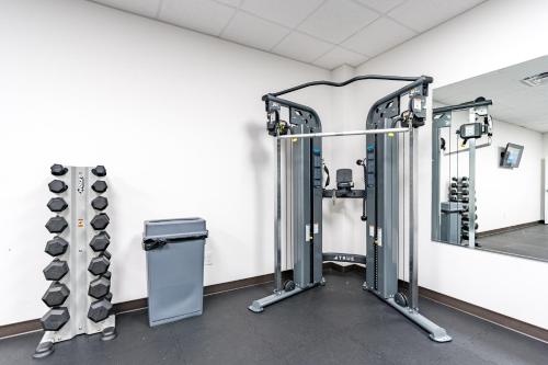 a gym with two treadmills and weights at Plantation East #1104 in Gulf Highlands