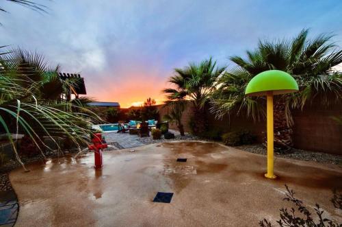 a red and green fire hydrant in a parking lot at Sand Hollow 3334 BBQ Grill, Private Splash Pad, Hot tub and Pool in Hurricane