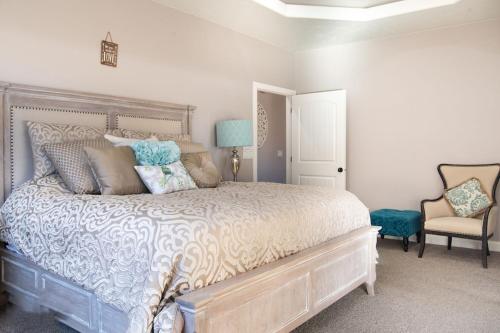 a bedroom with a large bed and a chair at Sand Hollow 3334 BBQ Grill, Private Splash Pad, Hot tub and Pool in Hurricane