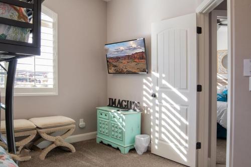 a bedroom with a blue cabinet and a window at Sand Hollow 3334 BBQ Grill, Private Splash Pad, Hot tub and Pool in Hurricane