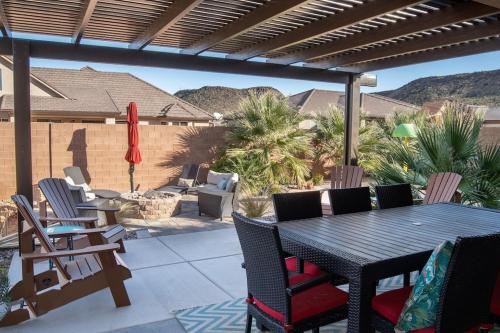 a patio with a table and chairs on a patio at Sand Hollow 3334 BBQ Grill, Private Splash Pad, Hot tub and Pool in Hurricane