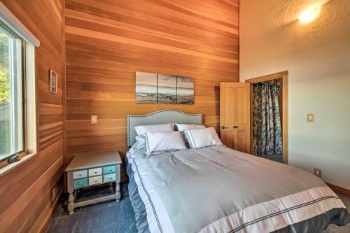 a bedroom with a bed with wooden walls and a window at Marrowstone Island Home 20 Mins to Port Townsend! in Nordland