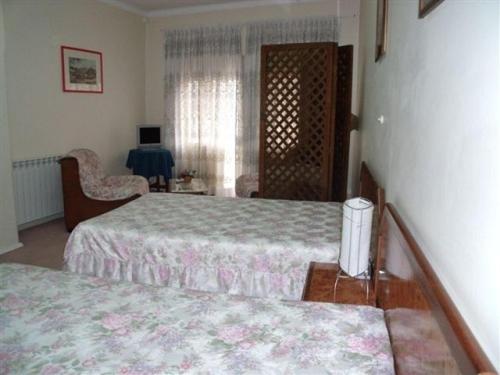Postel nebo postele na pokoji v ubytování D. Carlos Residencial