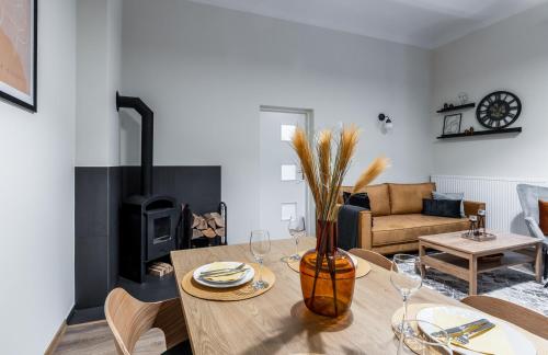 a living room with a table and a fireplace at BeeApartments Długosza 11 in Nowy Sącz