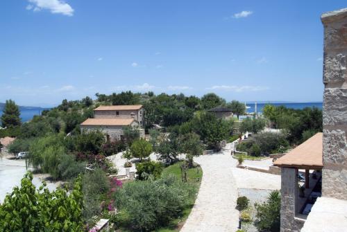 arial view of a villa with trees and a road at Smyros Resort in Poúlithra