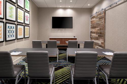 a conference room with tables and chairs and a tv at Holiday Inn Express & Suites - Bullhead City by IHG in Bullhead City