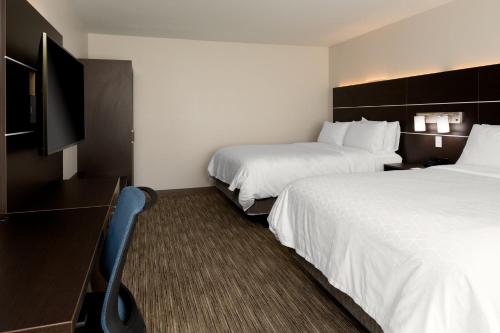 a hotel room with two beds and a flat screen tv at Holiday Inn Express & Suites - Bullhead City by IHG in Bullhead City