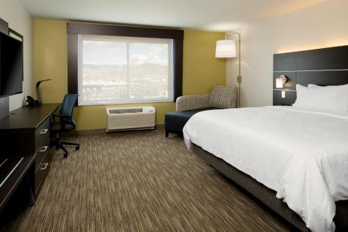 a hotel room with a large bed and a television at Holiday Inn Express & Suites - Bullhead City by IHG in Bullhead City