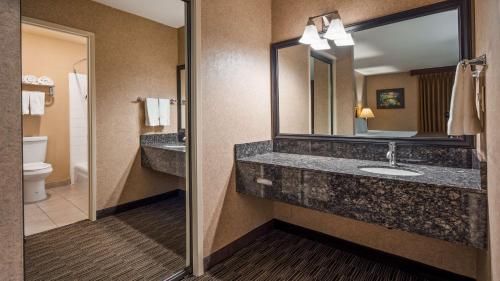 a bathroom with a sink and a mirror at Best Western La Posada Motel in Fillmore