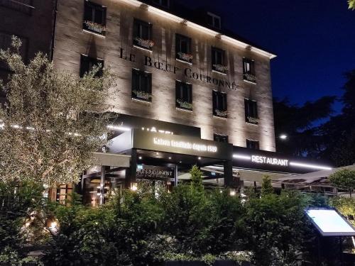 a building with a sign on the side of it at Hôtel Le Boeuf Couronné Chartres - Logis Hotels in Chartres