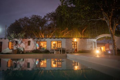 a house with a swimming pool at night at Tampu in Cachí