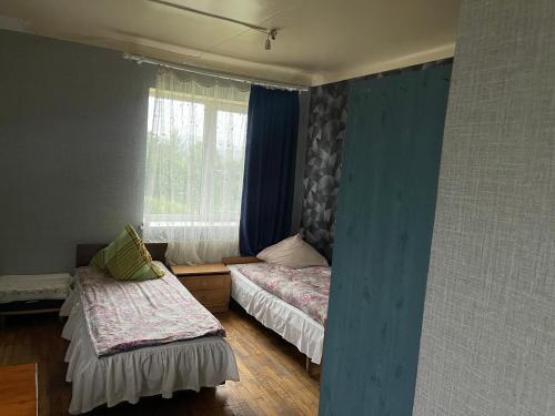 a room with two beds and a window at Nakts zvaigzne in Rēzekne