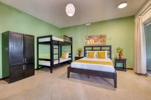a bedroom with a bed and a bunk bed at Terrazas del Caribe Hotel in Puerto Viejo