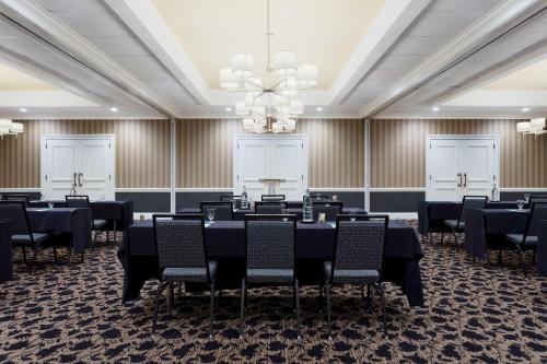 a conference room with tables and chairs and a chandelier at Sheraton Charlotte Hotel in Charlotte