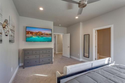 a bedroom with a bed and a tv on the wall at Zion Village 339 3 Bed, 2 and a half Bath, Game Systems, Mister System, and Community Pool in Hurricane