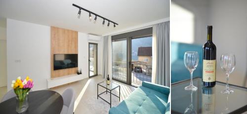 a living room with a bottle of wine and a table with wine glasses at Solaris Lux Apartments in Kotor