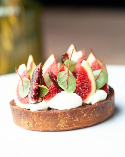 a dessert with strawberries and cream on a table at Le Boeuf Couronné - Hôtel & Restaurant Chartres- Logis Hotels in Chartres