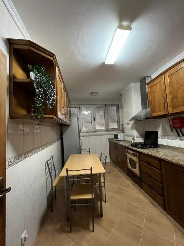 a small kitchen with a table and chairs in it at ApartDouro in Alijó