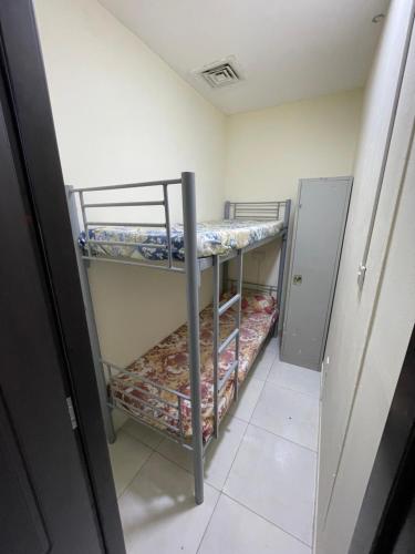 a small room with two bunk beds in it at WAA Hostel in Dubai
