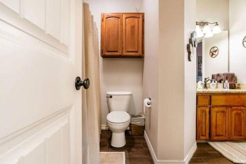 a bathroom with a toilet and a sink at Guadalupe Getaway in New Braunfels