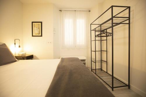 a bedroom with a bed with a glass shelf at Alojamientos Cantíber in Santander