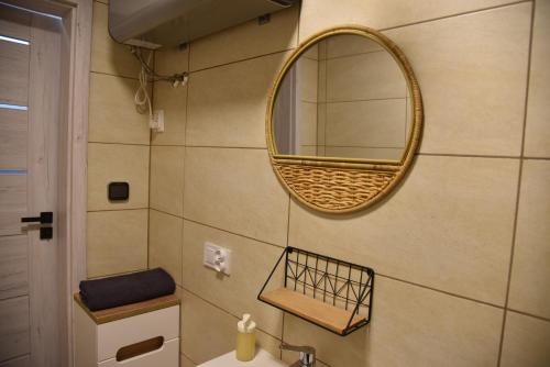 a bathroom with a mirror and a sink at Apartament Dworcowa in Kalisz