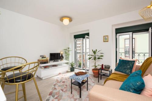 a living room with a couch and a tv at High on Lisbon in Lisbon