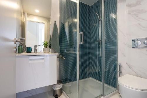 a bathroom with a glass shower and a toilet at High on Lisbon in Lisbon
