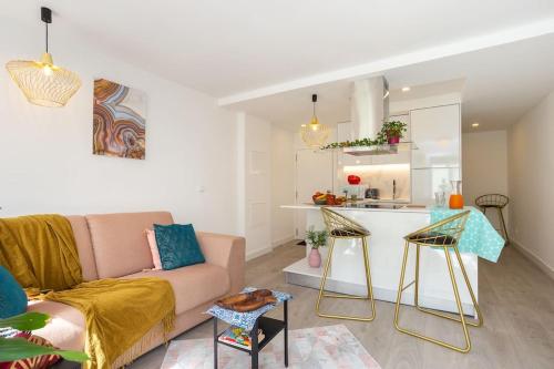 a living room with a couch and a kitchen at High on Lisbon in Lisbon