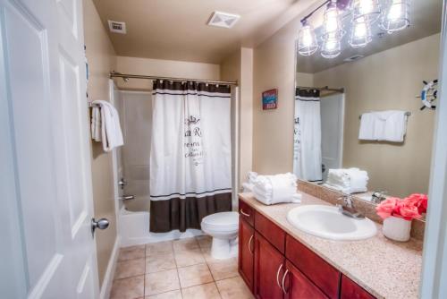 a bathroom with a sink and a toilet at Laketown Wharf Resort 1036 By Aneliya in Panama City Beach