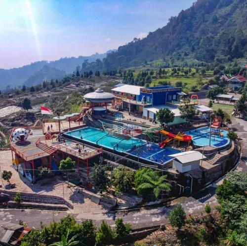 an overhead view of a water park with two pools at Curug Ciherang Villa & Glamping 