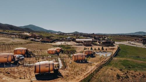 an aerial view of a farm with orange tanks at Finca el Mirador in Valle de Guadalupe