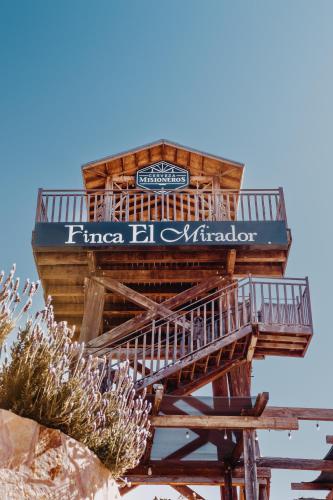 a tree house with a sign on top of it at Finca el Mirador in Valle de Guadalupe