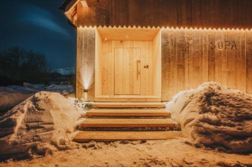 a building with a door in the snow at SOPA Zakopane in Zakopane