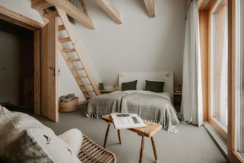 a bedroom with a bed and a book on a table at SOPA Zakopane in Zakopane