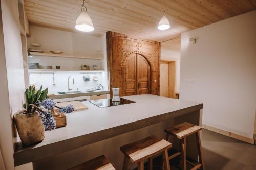 a kitchen with a counter and stools in a room at SOPA Zakopane in Zakopane