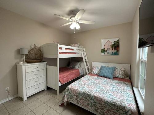 a childs bedroom with a bunk bed and a dresser at Barefoot Bungalow - Pet Friendly- 2 Bdrm Townhome in Corpus Christi