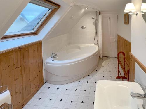 a bathroom with a large tub and a sink at Caladh Beag in Lochranza