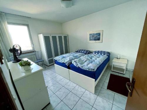 a bedroom with a bed with a blue comforter at Apartment Eldorado View in Lugano