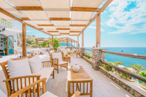 a restaurant with a view of the ocean at Hotel Ferdinando Beach & Thermal Spa in Ischia