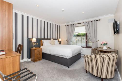 a bedroom with a bed and a desk and a window at Hillview House in Lusk